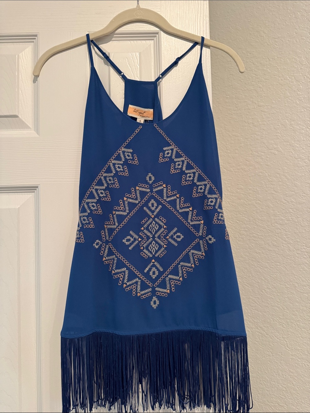 A top perfect for western wear with the embroidery design and fringe